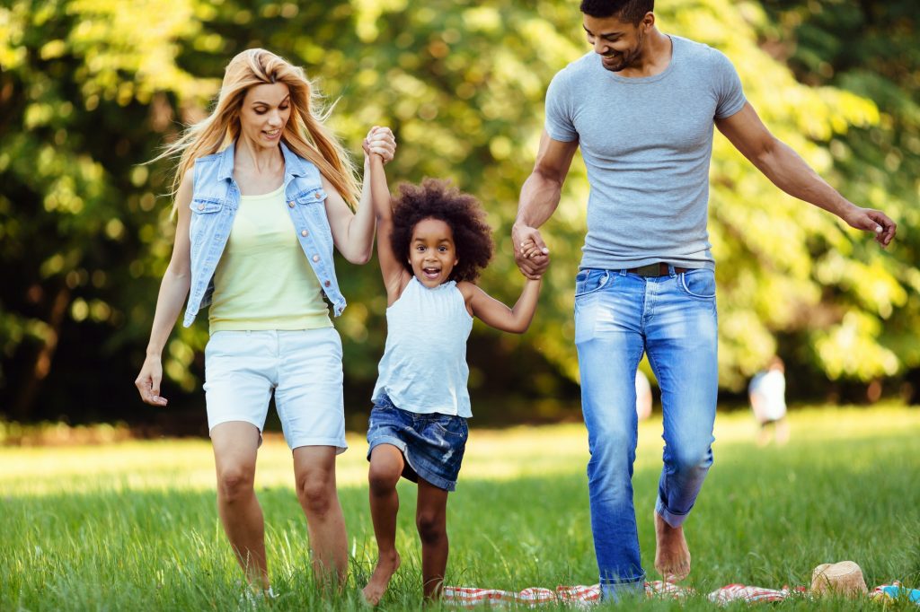 Happy young couple spending time with their daughter